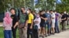 Voters wait in line to cast their ballot during advance voting at a polling station in a school in Narathiwat, southern Thailand, on May 7, 2023, a week ahead of the May 14 general election.