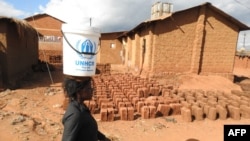 FILE — A refugee walks past drying bricks in the Dzaleka Refugee camp on World Refugee Day at Dzaleka Refugee Camp in Dowa District Central region of Malawi on June 20, 2018. 