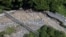 This drone shot shows a road damaged by a flash flood in Tanah Datar, West Sumatra, Indonesia, May 12, 2024. Heavy rains and torrents of cold lava and mud flowing down a volcano's slopes on Indonesia's Sumatra island triggered flash floods. 