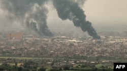 This image from AFPTV video on April 28, 2023, shows an aerial view of black smoke rising over Khartoum. Fighting raged in Sudan, despite rival forces agreeing to extend a truce aimed to stem nearly two weeks of warfare that has killed hundreds. 