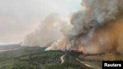 A smoke column rises from a wildfire near Shining Bank, Alberta, Canada, May 5, 2023. Alberta Wildfire/Handout via Reuters. 