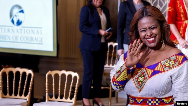 Meaza Mohammed from Ethiopia waves as she leaves the East Room of the White House after being honored at the 17th annual International Women of Courage (IWOC) Award Ceremony at the White House, March 8, 2023.