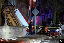 FILE - Authorities work the scene at the Apollo Theatre after a severe spring storm caused damage and injuries during a concert, in Belvidere, Illinois, March 31, 2023.