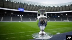 FILE - The Euro 2024 football trophy on display at the Olympic Stadium in Berlin, April 24, 2024. 