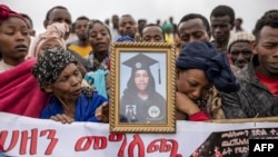 Relatives and residents gather together to mourn the death of their loved ones in a collective ceremony close to the scene of a landslide in Kencho Shacha Gozdi on July 26, 2024.