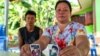 The parents of Natthaporn, who was working in Israel and has been abducted in the ongoing conflict between Israel and the Palestinian Islamist group Hamas, hold up his pictures at their house in Nakhon Phanom, Thailand, Oct. 10, 2023. 