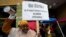 Teacher Sarah Harris joins Los Angeles Unified School District, LAUSD teachers and Service Employees International Union 99 members striking as rain falls outside the Edward R. Roybal Learning Center in Los Angeles, March 21, 2023. 