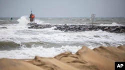 Waves break along the jetty at Rudee Inlet in Virginia Beach, Virginia, Sept. 22, 2023, as Tropical Storm Ophelia approaches the area.
