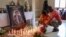 FILE - Mourners place candles at Radio Amplitude FM where a portrait of slain journalist Arsene Salomon Mbani Zogo, also known as "Martinez," has been placed as a tribute to him, in the Elig Essono district in Yaounde, Cameroon, Jan. 23, 2023. 