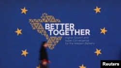 FILE - An attendee walks at the venue on the day of the EU-Western Balkans summit in Tirana, Albania, Feb. 29, 2024. A 2024 poll shows the once-strong support for European Union accession is declining.