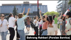 Iranians dance in Toronto, Canada, on May 20, 2024, to celebrate the death a day earlier of Iranian President Ebrahim Raisi, who was reviled by opponents of Iran's authoritarian Islamist rulers. (Behrang Rahbari/VOA Persian)