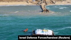 A World Central Kitchen barge loaded with food arrives off Gaza, where there is risk of famine after five months of Israel's military campaign, in this handout image released March 15, 2024. (Israel Defense Forces via Reuters)