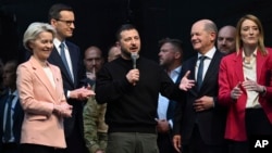 Ukraine's President Volodymyr Zelenskyy (C) talks after being awarded the Charlemagne Prize, in Aachen, Germany, May 14, 2023. (Federico Gambarini/DPA via AP)