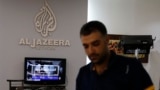 FILE - An employee of Qatar-based news channel Al Jazeera is seen at the media outlet's offices in Jerusalem, July 31, 2017.
