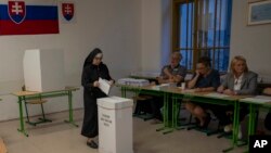 A Catholic nun casts her ballot at a polling station in Bratislava, Slovakia, Sept. 30, 2023.