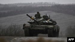 A Ukrainian army tank rolls along a road outside the area of Bachmut, in the region of Donbas, on March 15, 2023.