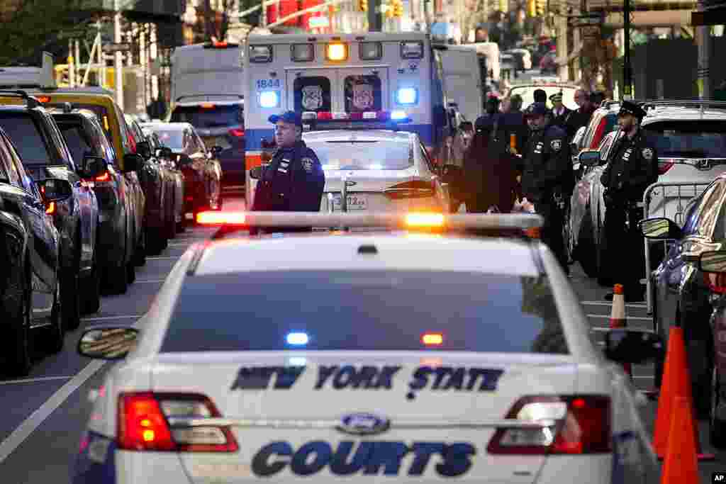 Security forces gather outside Manhattan Criminal Court, in New York. Former President Donald Trump is expected to travel to New York to face charges related to hush money payments. 