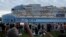 People film from South Pointe Park, as Icon of the Seas, the world's largest cruise ship, sails out of PortMiami on its first public cruise, in Miami Beach, Florida, Jan. 27, 2024. 
