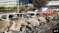Burnt-out cars are seen in the parking lot of the old hospital on the outskirts of Noumea, French territory of New Caledonia, May 16, 2024. 