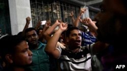 Supporters of Islamist leader Delwar Hossain Sayeedi chant slogans as they gather in front of a hospital, where he died following a heart attack, in Dhaka, Bangladesh, on Aug. 14, 2023. 