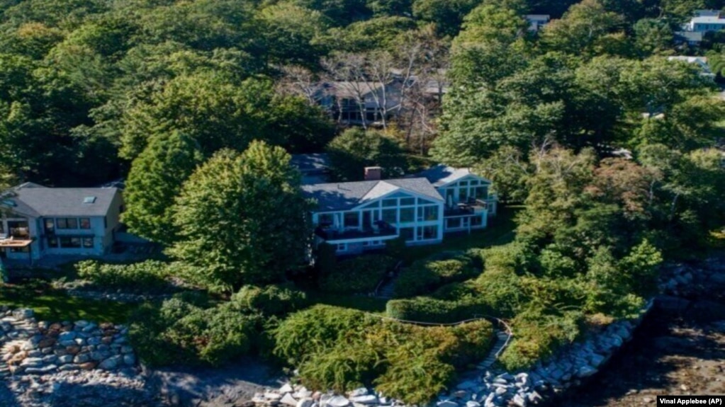 This undated image provided by Vinal Applebee shows the home of Lisa Gorman in the foreground, the poisoned oak trees behind her home, and the home of the perpetrators behind the dead trees, in Camden, Maine.