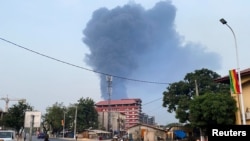 FILE - Smoke rises after a blast at an oil terminal in Conakry, Guinea December 18, 2023.