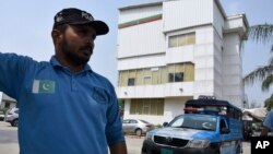 A police officer stands guard outside the office of Pakistan Tehreek-e-Insaf (PTI) party following police raid in office, in Islamabad, Pakistan, July 22, 2024. 