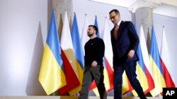 Poland's Prime Minister Mateusz Morawiecki welcomes Ukrainian President Volodymyr Zelenskyy as they meet in Warsaw, Poland, Apr. 5, 2023.