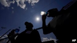 FILE - Umpires Raymond Herring, left, and Jerry Kelly take a break between innings during the DYB, formerly Dixie Youth Baseball, Little League tournament in Ruston, La., Aug. 9, 2023