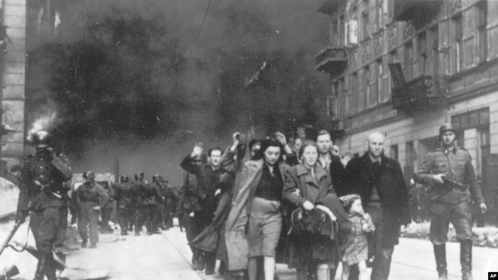 FILE - In this 1943 file photo, a group of Polish Jews are led away for deportation by German SS soldiers during the destruction of the Warsaw Ghetto. (AP Photo, File)