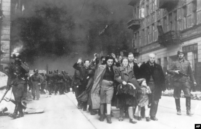 FILE - In this 1943 file photo, a group of Polish Jews are led away for deportation by German SS soldiers during the destruction of the Warsaw Ghetto. (AP Photo, File)