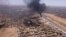 This image grab taken from AFPTV video footage on April 20, 2023, shows an aerial view of black smoke rising above the Khartoum International Airport amid ongoing battles between the forces of two rival generals.