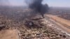 This image grab taken from AFPTV video footage on April 20, 2023, shows an aerial view of black smoke rising above the Khartoum International Airport amid ongoing battles between the forces of two rival generals.