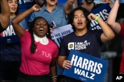 Supporters cheer as Democratic presidential candidate Vice President Kamala Harris speaks at a campaign rally at the Desert Diamond Arena in Glendale, Arizona, August 9, 2024.