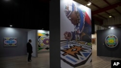 A delegate looks at an exhibition of Ndebele art at the Africa Growth and Opportunity Act (AGOA) Forum in Johannesburg, Nov. 4,2023. 