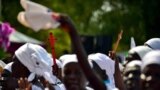 FILE - Church members dance as they welcome the Archbishop of Cantebury Justin Welby at the ECS All Saints church in Juba on Jan. 30, 2014.