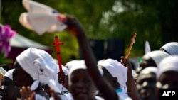 FILE - Church members dance as they welcome the Archbishop of Cantebury Justin Welby at the ECS All Saints church in Juba on Jan. 30, 2014.