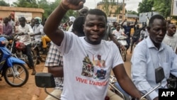 A protester wearing a T-shirt in support of the Niger, Mali, Guinea and Burkina Faso junta leaders gestures during a demonstration in Niamey, Niger, on Aug. 3, 2023. 