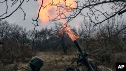 Volunteer soldiers fire towards Russian positions close to Bakhmut, Donetsk region, Ukraine, Wednesday, March 8, 2023.