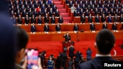 中国领导人习近平在北京人大会堂举行的全国人大会议上宣誓连任国家主席第三任期。（2023年3月10日）
