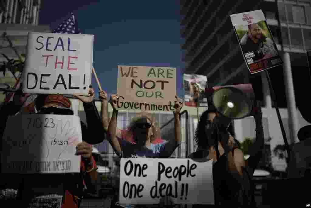 Families and supporters of Israeli hostages held by Hamas in Gaza hold banners and flags during a protest calling for their return, outside meetings of U.S. Secretary of State Antony Blinken in Tel Aviv, Israel.