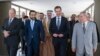 In this photo released by the official Telegram account of the Syrian Presidency, Syrian President Bashar Assad walks with a delegation representing various Arab parliaments in Damascus, Feb. 26, 2023. (Syrian Presidency via Telegram via AP)