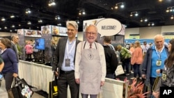 Berkshire Hathaway shareholders pose with a cutout poster of CEO Warren Buffett in Omaha, Nebraska, May 3, 2024. 