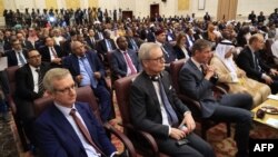 FILE - Aidan O'Hara, left, E.U. ambassador to Sudan, attends the signing ceremony of an initial deal between military and civilian leaders in Khartoum, Sudan, on Dec. 5, 2022. 