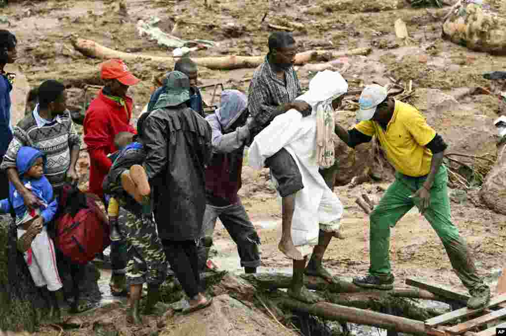 An injured man is helped in Blantyre, Malawi, March 13, 2023. Cyclone Freddy, which is currently hitting southern Africa, has killed more than 50 people in Malawi and Mozambique since it struck the continent for a second time.&nbsp;