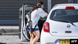 A shopper&nbsp;carrying an M16 assault rifle exits a store in Sderot in southern Israel.