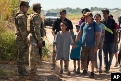 Migrants who crossed into the U.S. from Mexico are directed to a processing center, Sept. 21, 2023, in Eagle Pass, Texas.