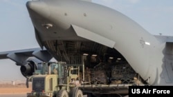 FILE - A U.S. Air Force Airman offloads cargo from a C-17 Globemaster III at Air Base 201, Niger, April 26, 2023. 