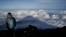 FILE - The shadow of Mount Fuji is cast on clouds hanging below the summit Aug. 27, 2019, in Japan. 