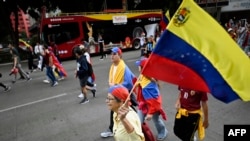 A woman holds a Venezuelan flag during a protest against the result announced for the Venezuelan presidential election at the Reforma Avenue in Mexico City on Aug. 10, 2024. 